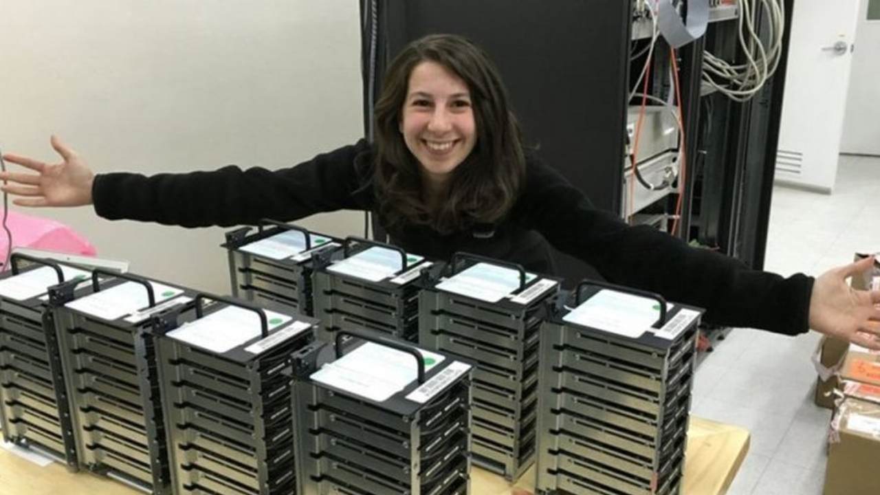 Katie Bouman with stacks of hard drives at MIT