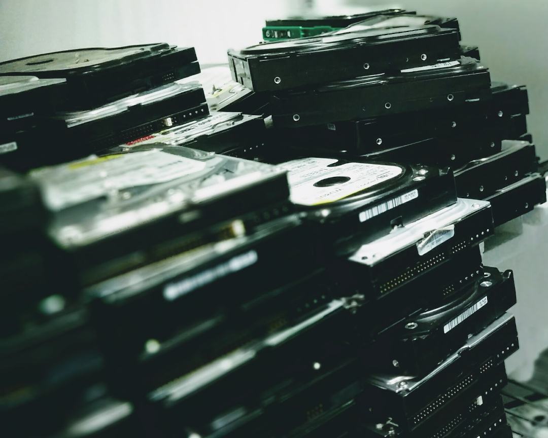 Photo of many hard drives stacked up on a shelf by CBL Data Recovery