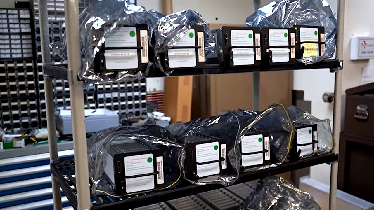Hard disk drive packs with handles on a shelf wrapped in anti-static bags at a correlation and analysis center for working on collected data from the Event Horizon Telescope. Photo from the Center for Astrophysics | Harvard & Smithsonian (CfA).